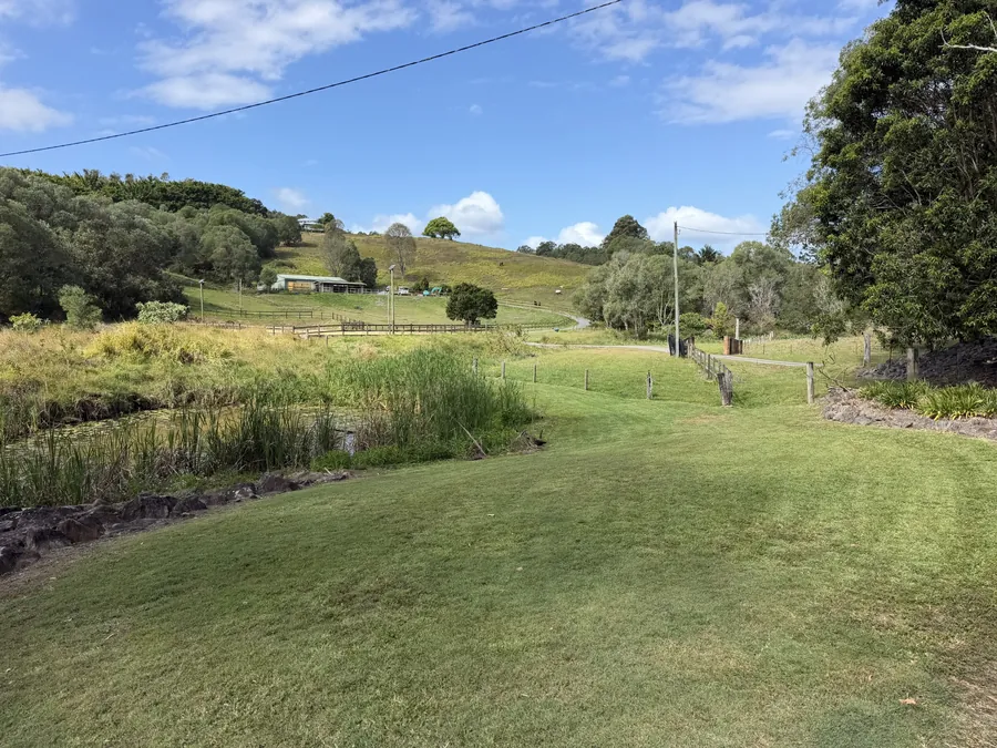 Acreage lawn mown down to the dam, horse yards behind — acreage mowing Gold Coast