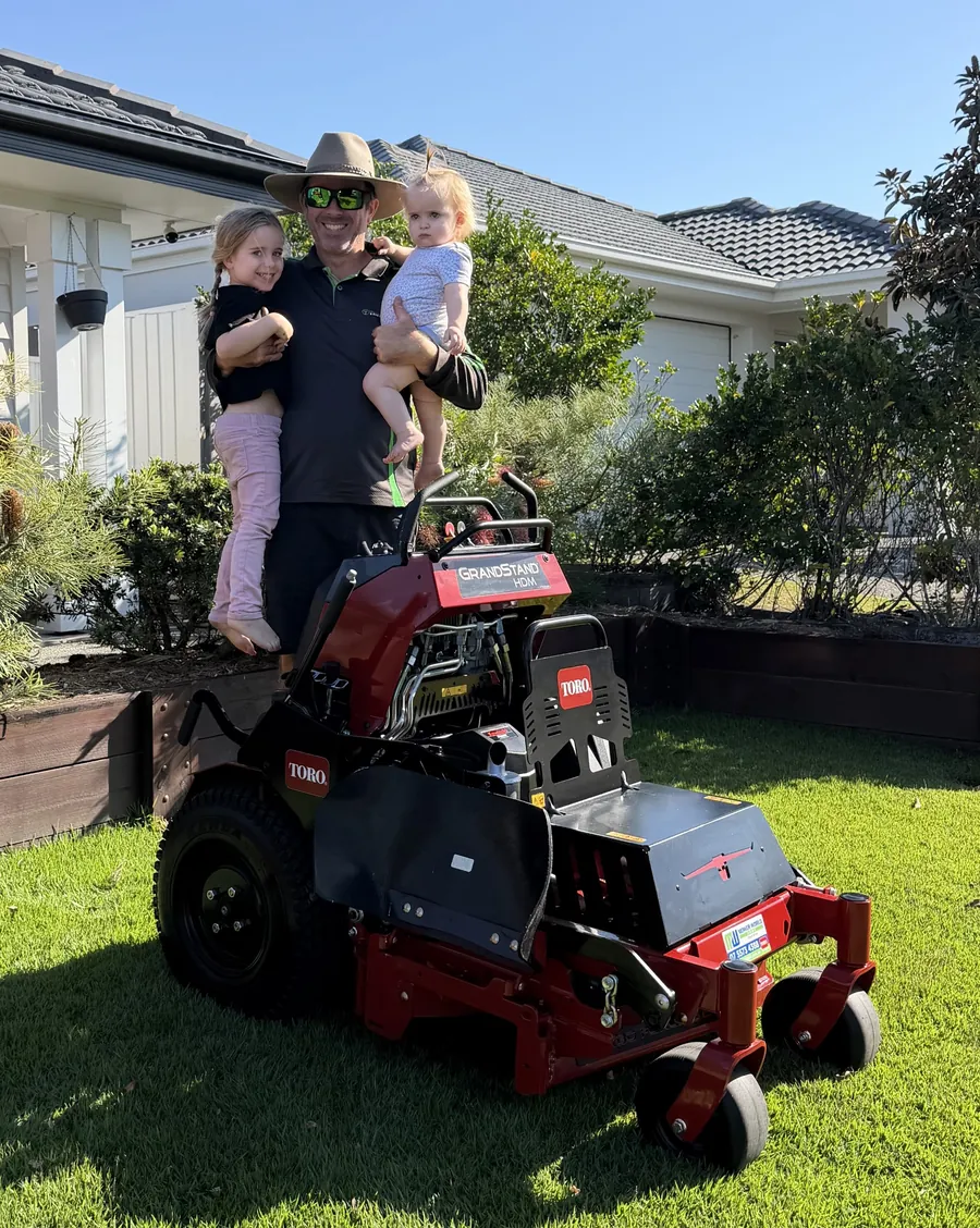 Shanon and the kids with the stand-on mower — family-owned lawn mowing, Northern Gold Coast