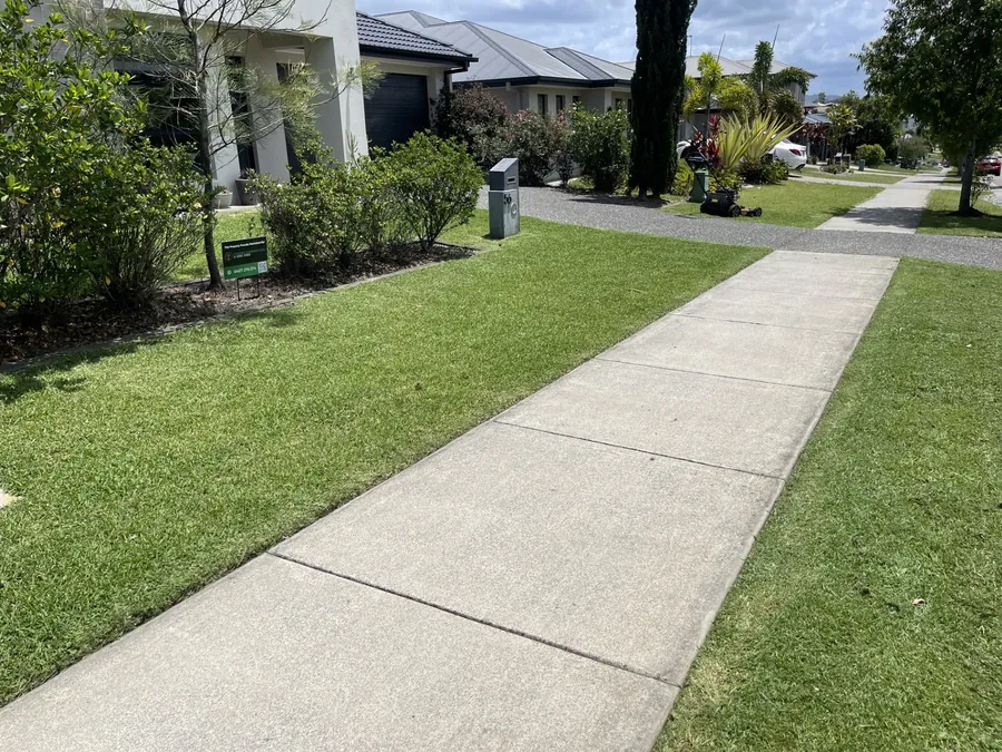 Nature strip and front lawn mown on a new-estate street — lawn mowing Coomera growth belt